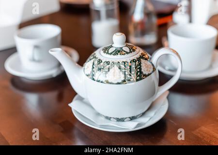 Teapot and two cups on a table in cafe Stock Photo