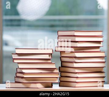 The stack of books arranged the office desk Stock Photo