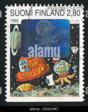 FINLAND - CIRCA 1995: stamp printed by Finland, shows Spaceman getting Letter, circa 1995 Stock Photo