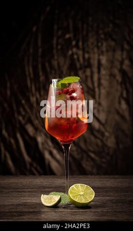Raspberry lemonade with lime and ice. Cold refreshing cocktail Stock Photo