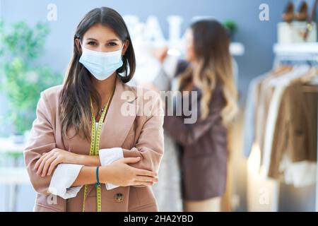 Young nice tailor woman with measure tape Stock Photo