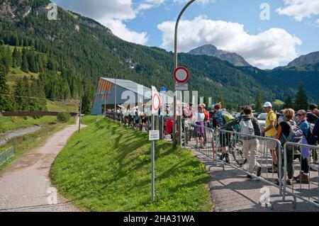 Queue of people waiting to take the cable car to Col Rodella in Campitello di Fassa, Fassa Valley, Trento, Trentino-Alto Adige, Italy Stock Photo