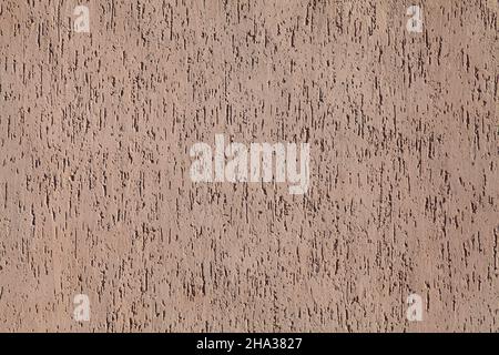 Brown wall, texture, background. Decorated surface with vertical embossed pattern. Chaotic, abstract strokes on the wall surface Stock Photo