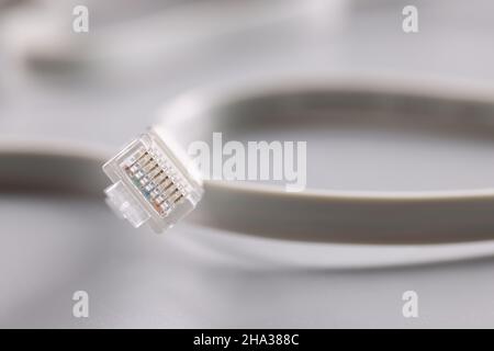 Computer patch cord cable on gray background. Fiber optic communication concept Stock Photo