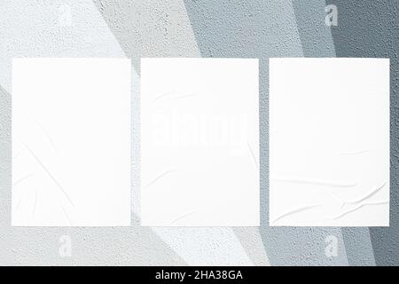 gray painted urban wall with wrinkled glued poster templates Stock Photo