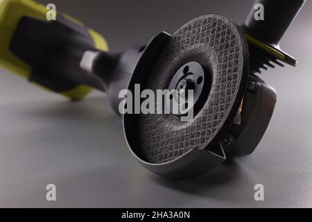 Angle pneumatic grinders grinder with disc on gray. Modern rechargeable power reinforcement grinder concept Stock Photo