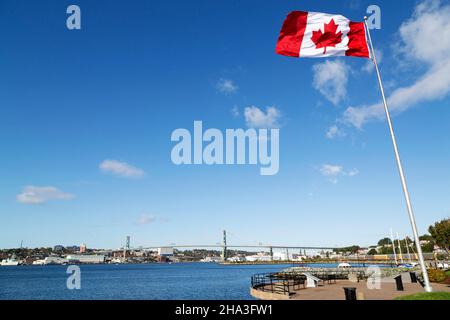 The Canadian flag flies from a flagpole at the Alderney Gate Ferry Terminal (Dartmouth Ferry Terminal) in Nova Scotia, Canada. Stock Photo