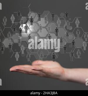 Group of 3D rendered people icons hovering over a man's hand holding a ...