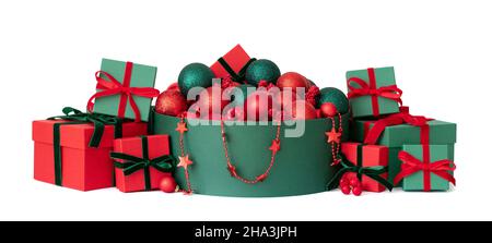 Christmas composition with gifts and festive decor isolated on white background. Red and green Christmas decorations. Happy New Year. Stock Photo