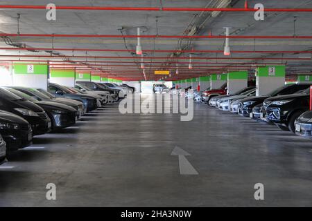 large parking for ground vehicles, parking lot in a building. Stock Photo