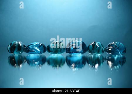 Blue glass crystals on blue background. Stock Photo