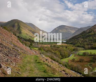Footpath descending from Boredale Hause to Hartsop and Patterdale. Red Screes visible above Brothers Water, Lake District, UK Stock Photo