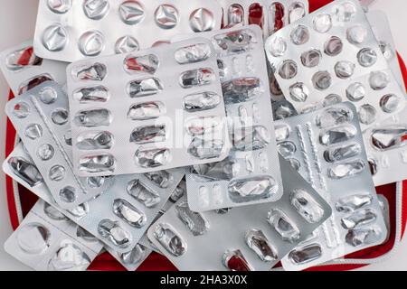 Side effects of pills and medication. Many used empty pills pack and medications silver blisters close up background Stock Photo