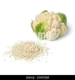 Heap of fresh cut cauliflower rice and whole cauliflower isolated on white background Stock Photo