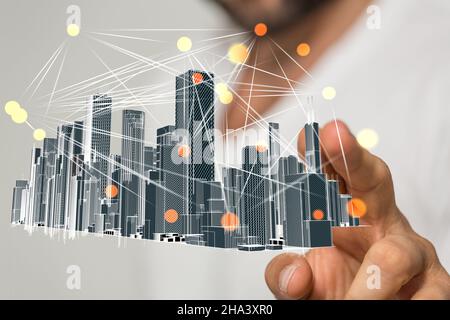Businessman hovering a modern cityscape floating on his hand Stock Photo