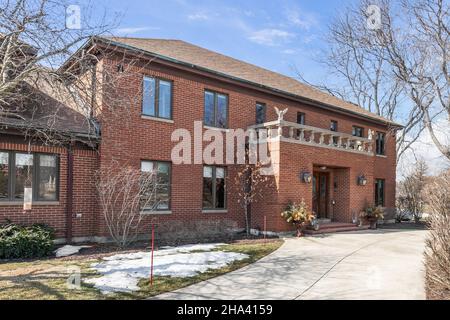 A luxury brick home in the spring with a wrap around driveway. Stock Photo