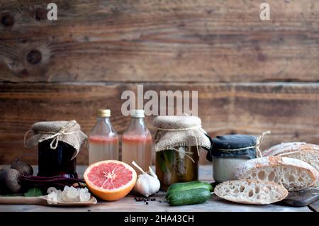 Fermented grains including sourdough and kefir, as well as lacto fermented vegetables in jars, beetroot, cucumbers Stock Photo