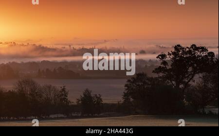 Winter Sunrise with Windsor castle emerging from mist on horizon Stock Photo