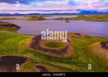 aerial panoramic view of myvatn,iceland at epic sunset. volcanic craters in green plaints and link clouds and sky. Stock Photo