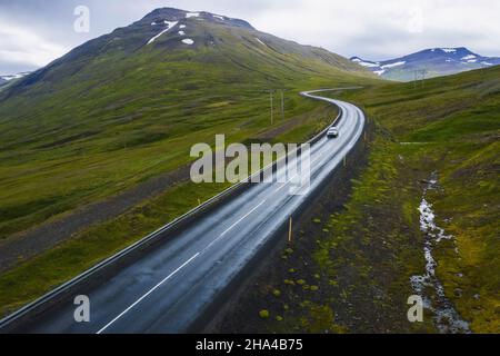lonely car drive on beautiful remote road,travel background,aerial scenic landscape from iceland. Stock Photo