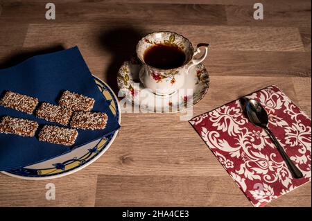 composition cup tea biscuits with sugar bowl on wooden top Stock Photo