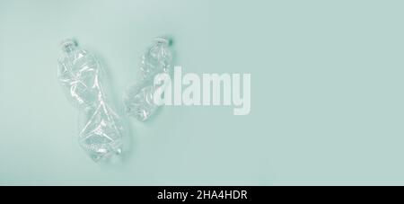 Used rumpled plastic bottles on green background. Ecology problem. Top view, copy space. Plastic trash. Stock Photo