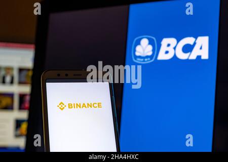 In this photo illustration the Binance logo is seen on the screen of a smartphone with a Central Bank of Asia logo on the background. (Photo by Paco Freire / SOPA Images/Sipa USA) Stock Photo