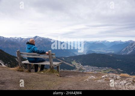 man looks out over the alps from seefelder joch,seefeld,tyrol,austria Stock Photo