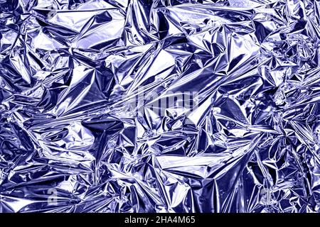 Modern beautiful holographic wrinkled foil background Stock Photo