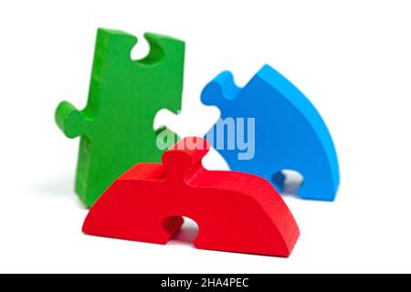 Colorful wooden puzzle pieces against white background Stock Photo