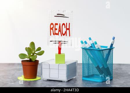Text showing inspiration Reach. Conceptual photo the distance within which something can be touched or grabbed Tidy Workspace Setup Writing Desk Tools Stock Photo