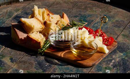 greece,greek islands,ionian islands,kefalonia,winery,gentilini,meze served on a wooden table as an addition to the wine tasting,wine bottles lined up,red,white and rose –© Stock Photo