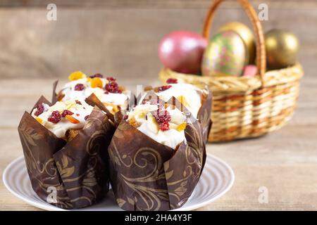 Easter eggs in a basket on a rustic wooden background. Easter background. Happy easter eggs on nest. Multi-colored Easter eggs. Stock Photo