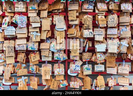 tokyo, japan - september 17 2021: A lot of Shinto timber votive plaques called Ema illustrated by worshippers with illustrations of tv anime character Stock Photo
