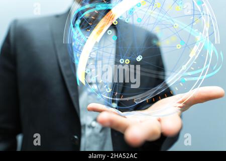 A sphere hologram made of intersecting lines and connected dots on a businessman's palm Stock Photo