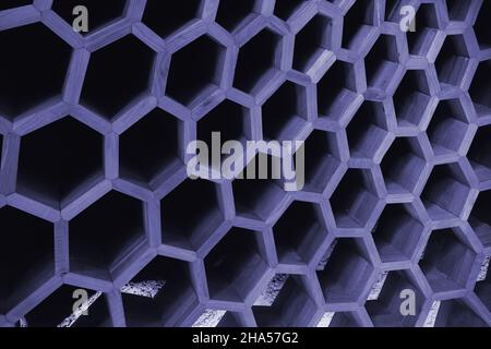 Color of the Year 2022. Abstract background in trendy color Very Peri. Big honeycombs made of wood Stock Photo