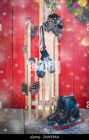 Sledge with winter time things, ice skates, gloves and hat. Stock Photo