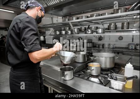Chef cooking in modern industrial kitchen. High quality photo Stock Photo
