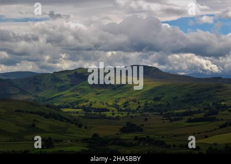Sun breaking through the clouds onto a mountain in the Lake District, as seen from the south facing slope of Blencathra (Cumbria, England) Stock Photo
