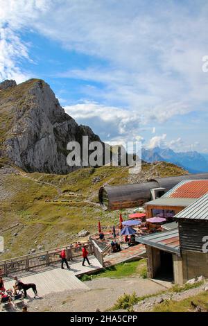 hikers,tourists at the nature information center bergwelt karwendel with giant telescope,karwendelbahn mountain station,mountain station,karwendel mountains,mittenwald,bavaria,germany Stock Photo