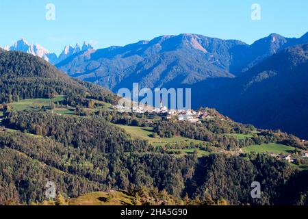 view of the village of teis with the parish church of the holy heart of jesus,in the background the geißlerspitzen,brixen,south tyrol,italy Stock Photo