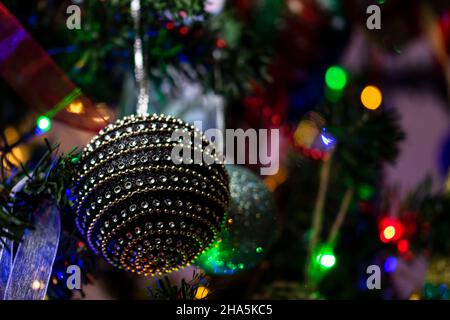 Closeup shot of ornaments and decorations on Christmas tree Stock Photo