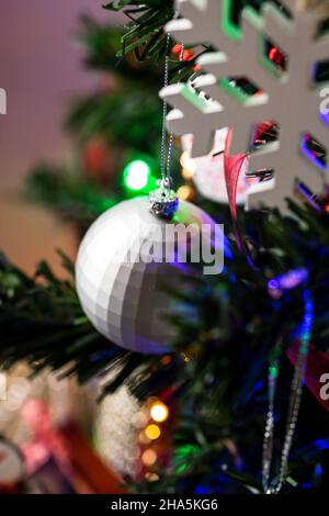 Vertical shot of ornaments and decorations on Christmas tree Stock Photo