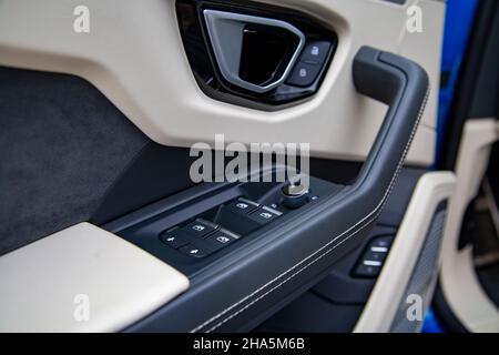 Interior of modern car. Side door buttons: window, mirror adjustment buttons, door lock. Car inside. Stock Photo