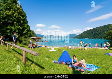 walchensee (lake walchen),beach,bather,standup paddleboarding (sup) in upper bavaria,bavaria,germany Stock Photo