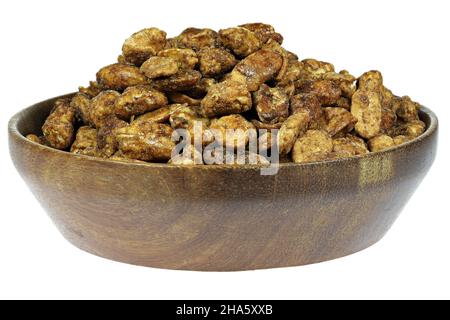 candied peanuts in a wooden bowl isolated on white background Stock Photo