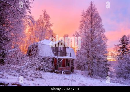 abandoned cottage in winter landscape during sunrise Stock Photo