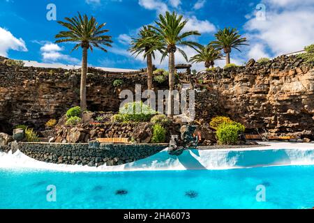 tropical garden with swimming pool,jameos del agua,art and cultural site,built by césar manrique,spanish artist from lanzarote,1919-1992,lanzarote,canaries,canary islands,spain,europe Stock Photo