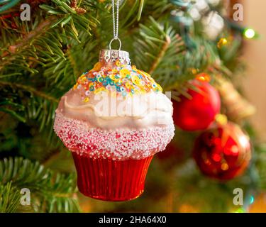 Christmas cupcake ornament hanging on the Christmas tree. Stock Photo
