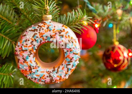 Glass Christmas donut hanging on the Christmas tree. Stock Photo